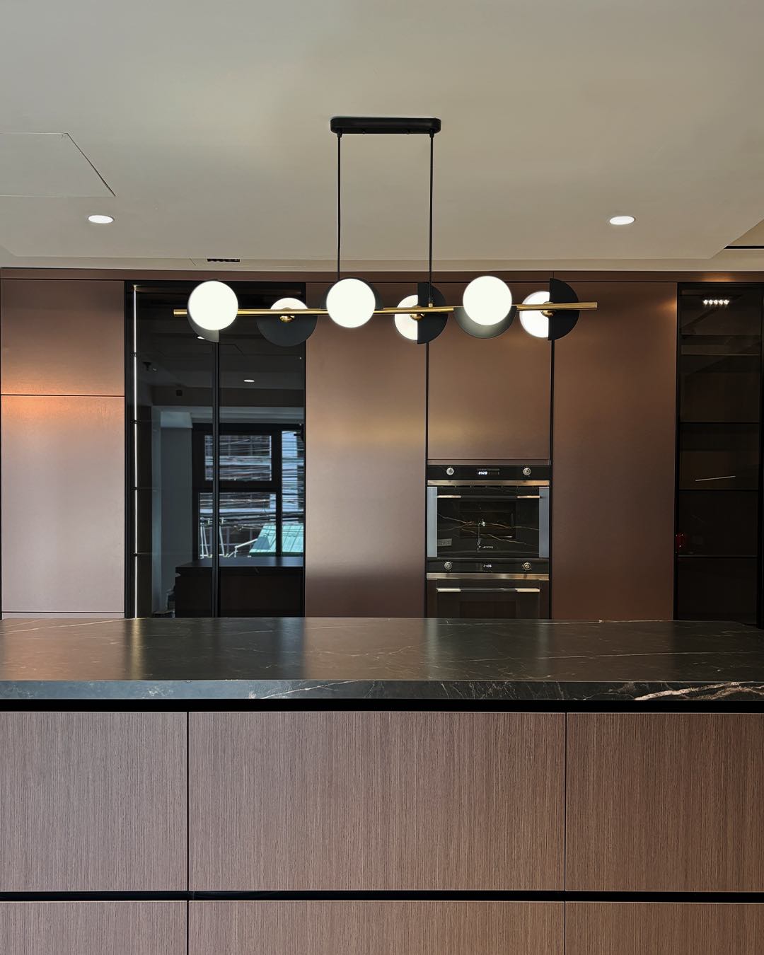 Caelum linear pendant lamp with graphic sphere accents