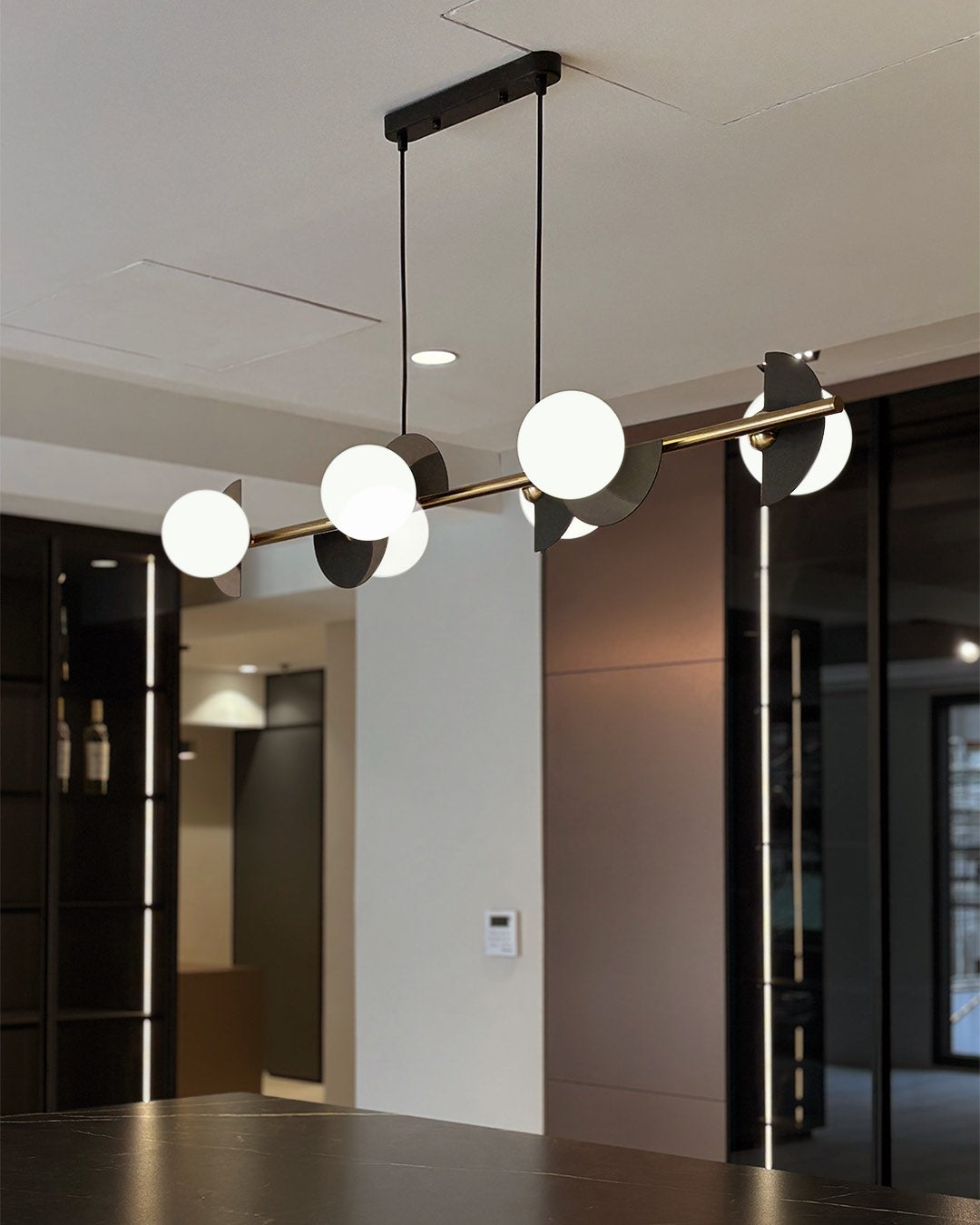 Caelum linear pendant lamp with graphic sphere accents