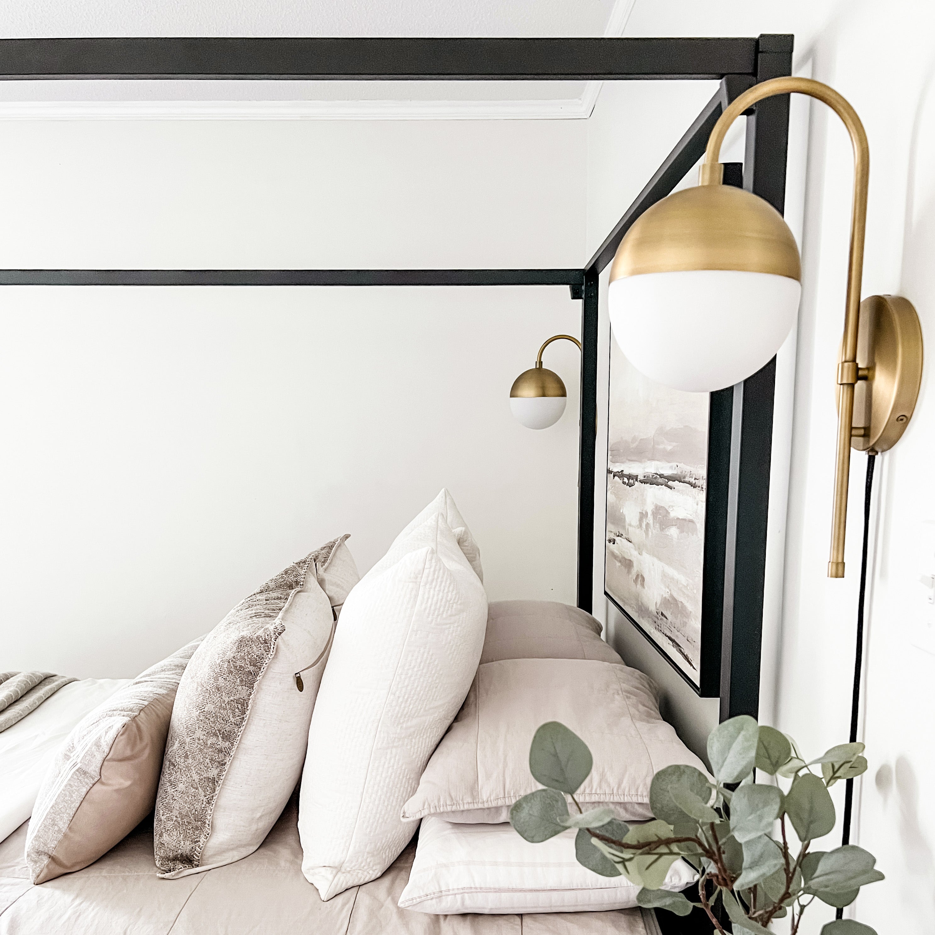 Wall lamp with curved brass frame and opal glass globe