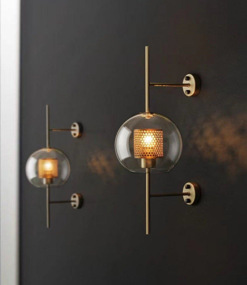 Wall lamp with glass globe and perforated light core
