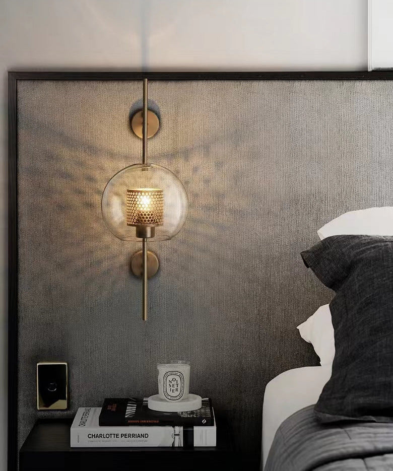 Wall lamp with glass globe and perforated light core
