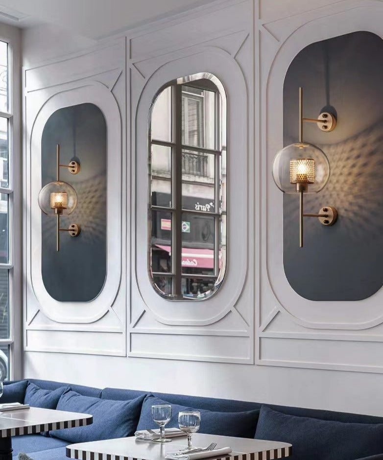 Wall lamp with glass globe and perforated light core